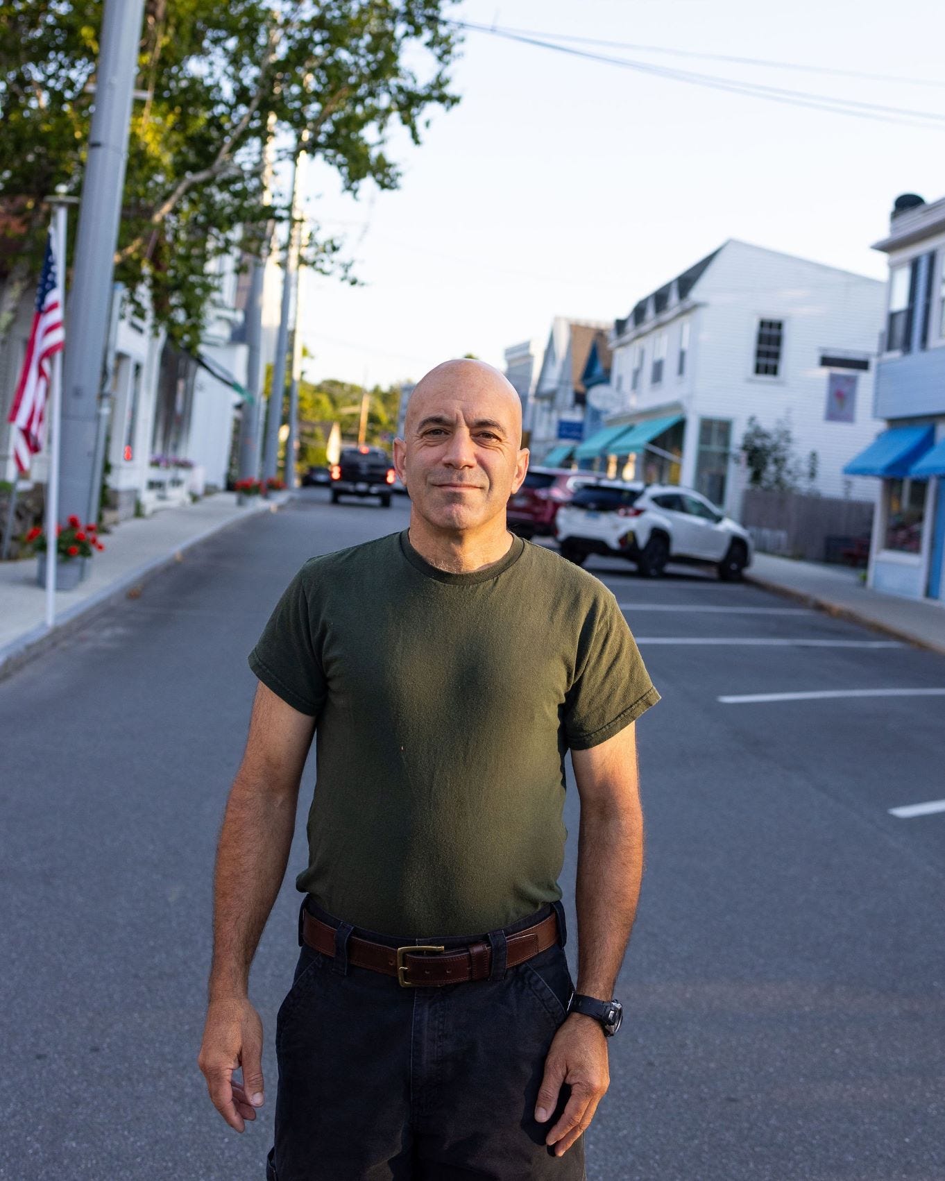 Steve Anastasia poses for a photo surrounded by businesses.