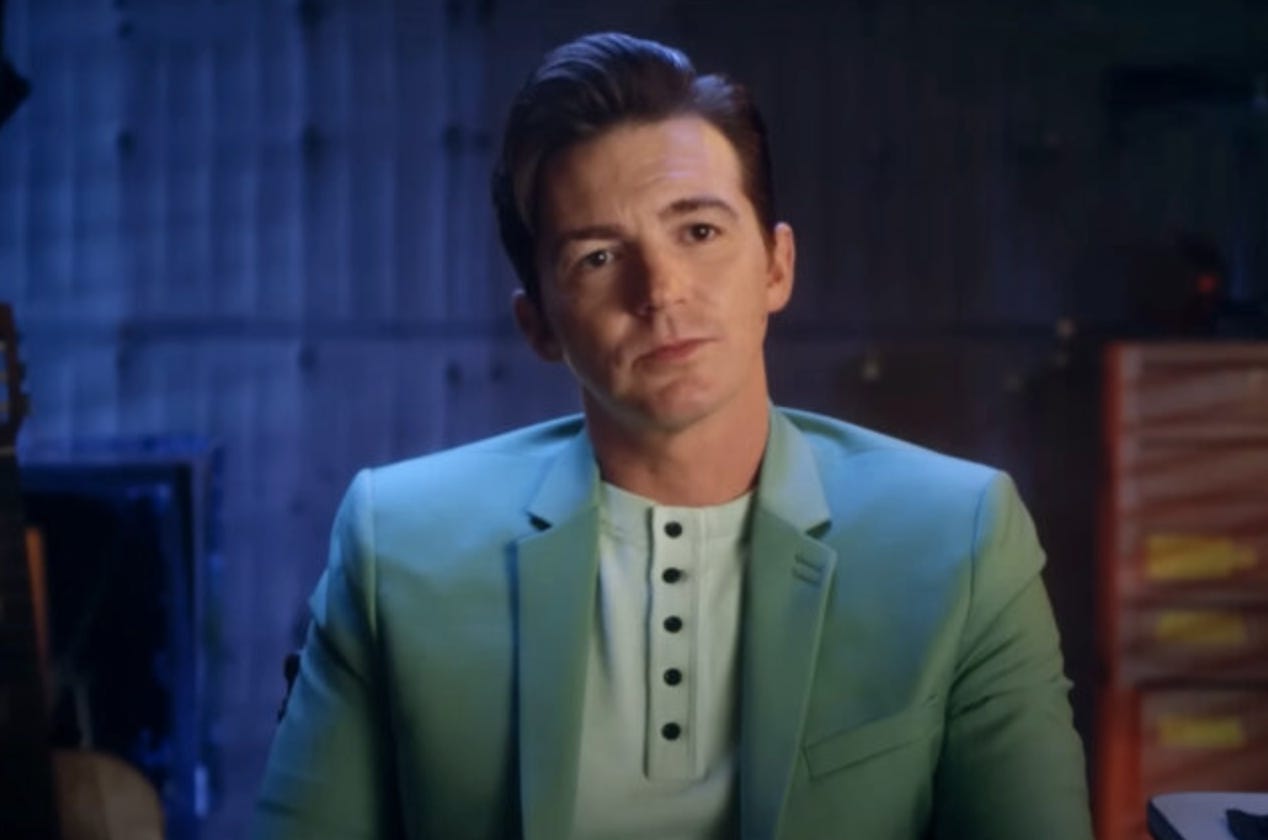Drake bell in a light blue suit facing the camera as part of the documentary Quiet on Set
