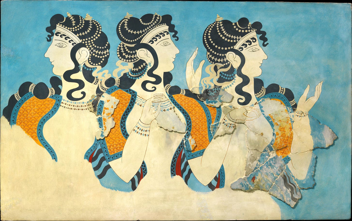 An ancient Minoan fresco picturing three women from the waist up on a blue background. The women all have long black hair decorated with strings of beads. They're wearing golden yellow short-sleeved tops with blue trim; the fronts are open to reveal their breasts. Each of the women is wearing multiple necklaces and bracelets.