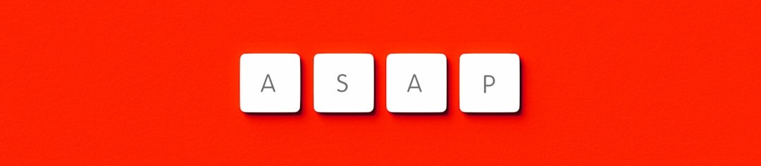 the word asap spelled with scrabble letters on a red background