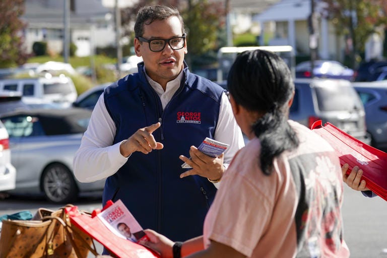 2022 Republican candidate Santos talks to a voter while campaigning in Glen Cove, N.Y. (Mary Altaffer/AP)