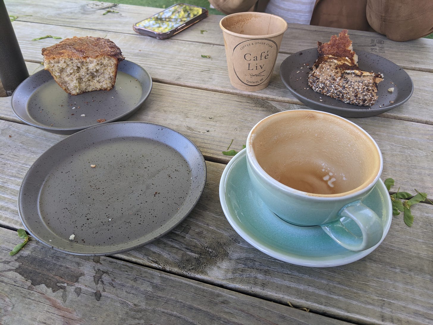 A set of empty plates and coffee mugs on a table