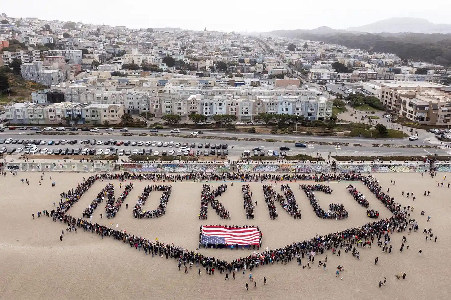 A human banner at Ocean Beach during the No Kings protests in San Francisco on Saturday, June 14, 2025. The protest is among nationwide demonstrations against President Donald Trump