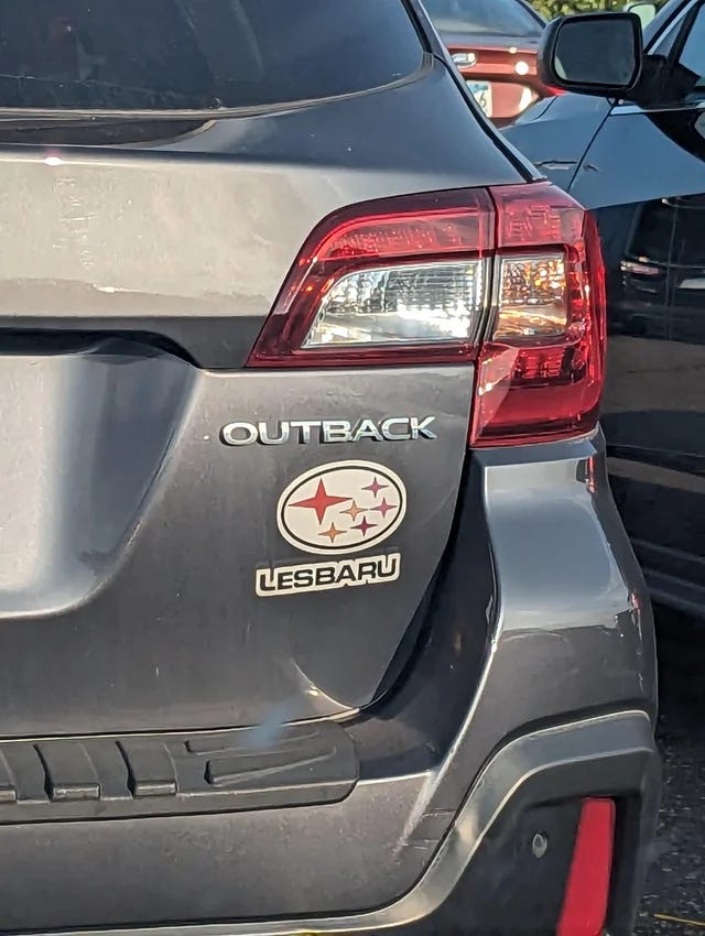 Outback car with a sticker under that says Lesbaru