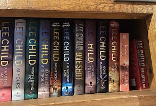 My book shelf - or at least a section of it. There are 12 Lee Child books in a row.