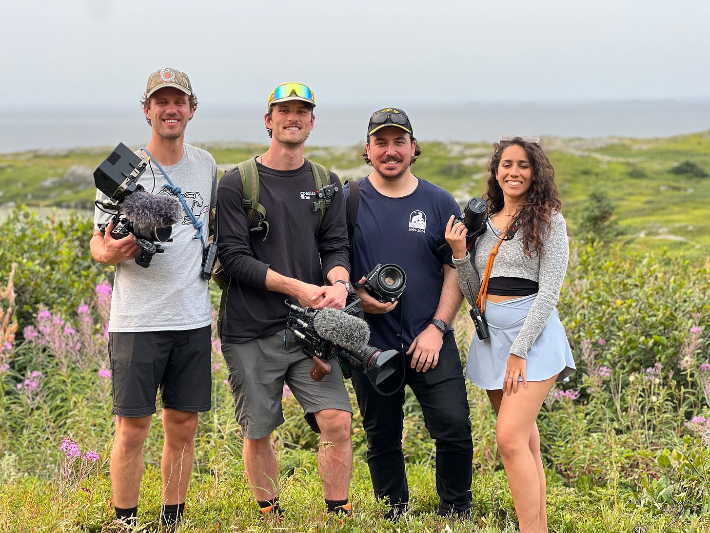 The Blue Future Pathways Media Team pose for a photo in a field of green and purple plants.