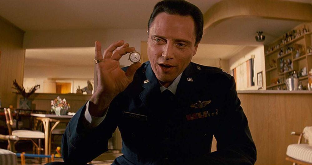 Screenshot from Pulp Fiction (1994). A man is holding a watch that has been hidden for several years inside the rectums of two men in a prisoner of war camp; the watch is now being handed down to the son of one of the men.