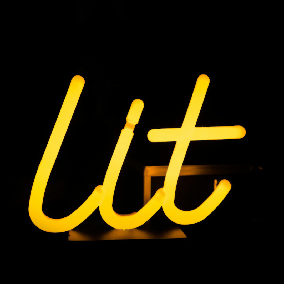 In pure darkness, a bright, friendly yellow neon light says “lit” In pure darkness, a bright, friendly yellow neon light says “lit”