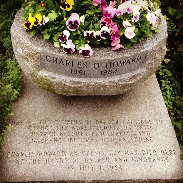 An image of the planter and plaque at the Charlie Howard memorial in Bangor, Maine. It shows his dates of life (1961-1984) and inscription "May we, the citizens of Bangor, continue to change the world around us until hatred becomes peacemaking and ignorance becomes understanding. Charlie Howard, and openly gay man, died here at the hands of hatred and ignorance on July 7, 1984."