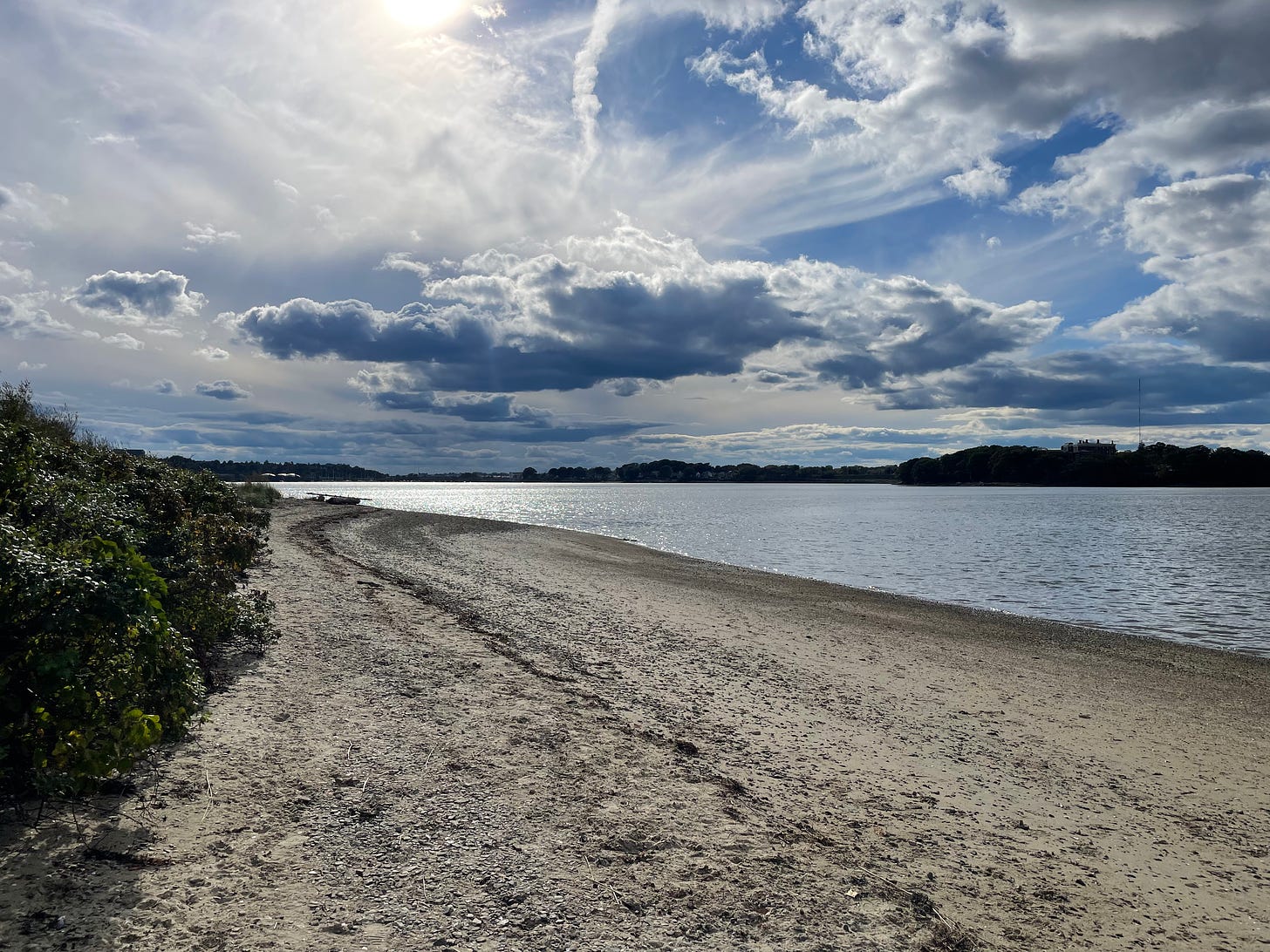 Mackworth Island, Maine on a beautiful fall day, with blue water, blue skies and an empty beach.