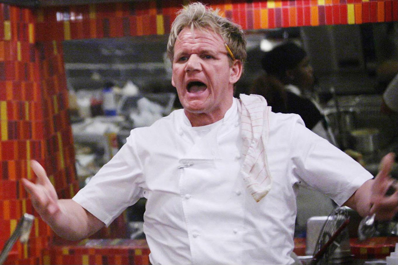 Gordon Ramsay in chef's whites, yelling something profane with his arms wide in disbelief.