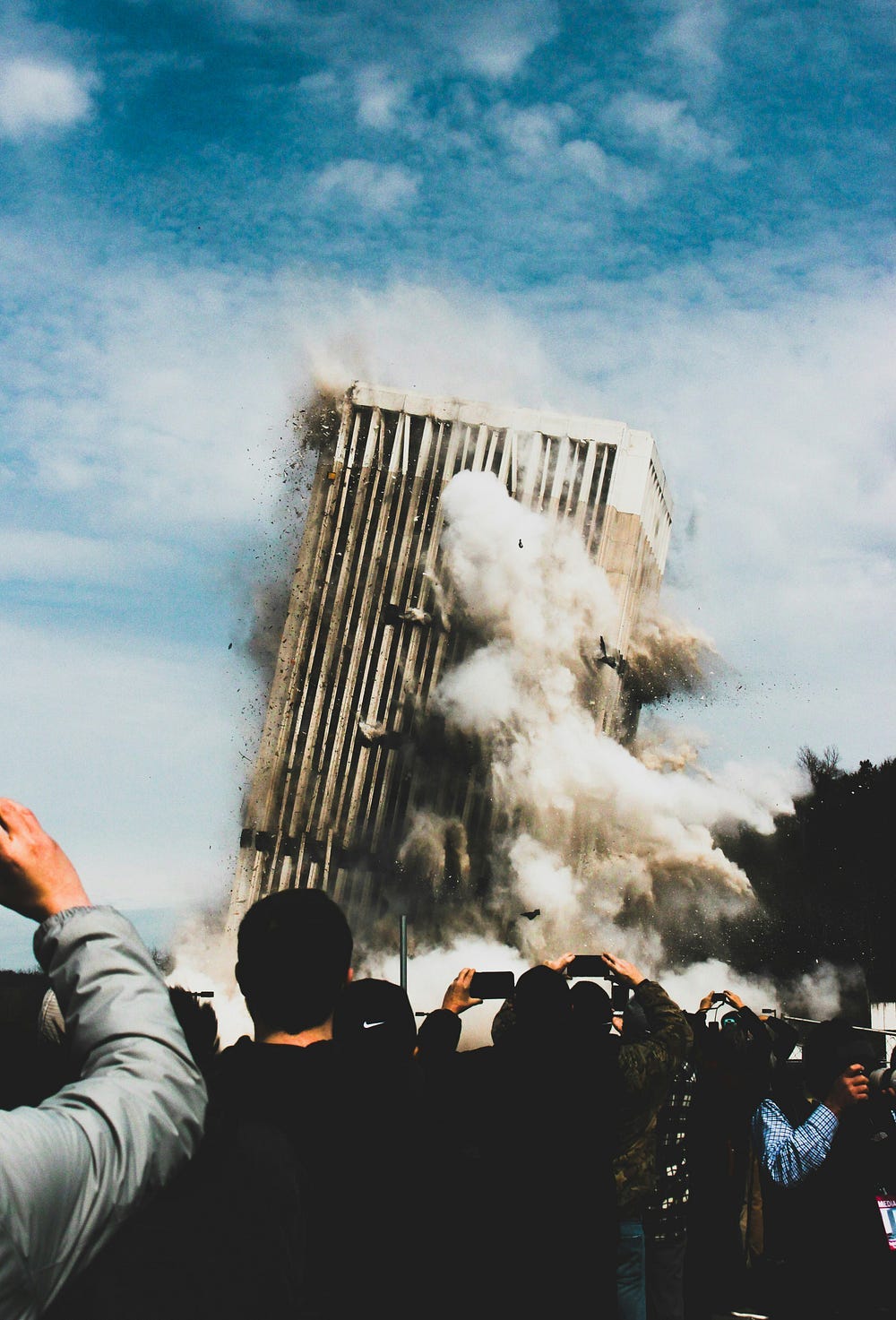 A high rise building explodes and collapses.