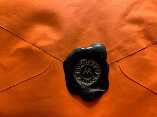 Wax seal on back of orange envelope