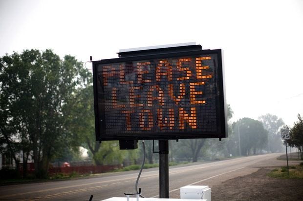 An evacuation sign asks residents to leave June 9, 2011 in Eagar, Arizona.