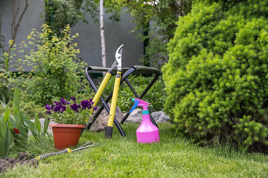 garden tools, stool, lawn and border ready to clear