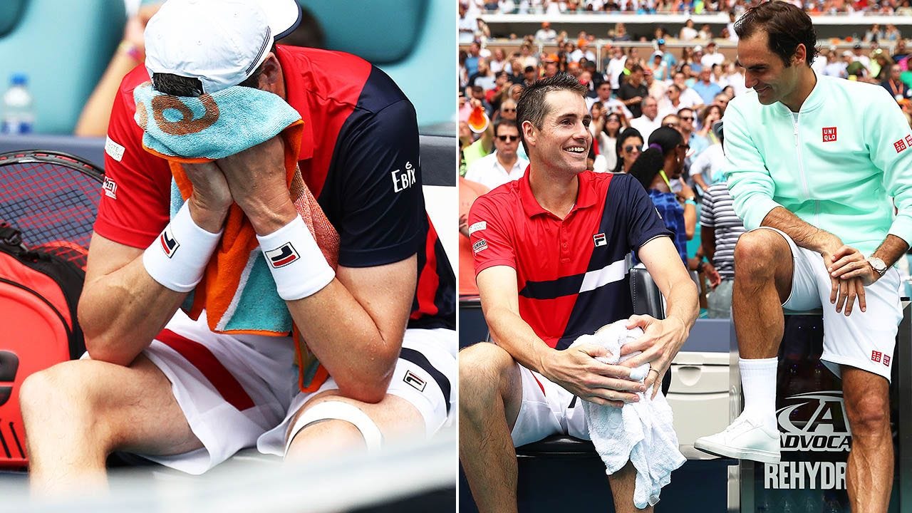 Roger Federer checking on John Isner injury after beating him at 2019 Miami Open.