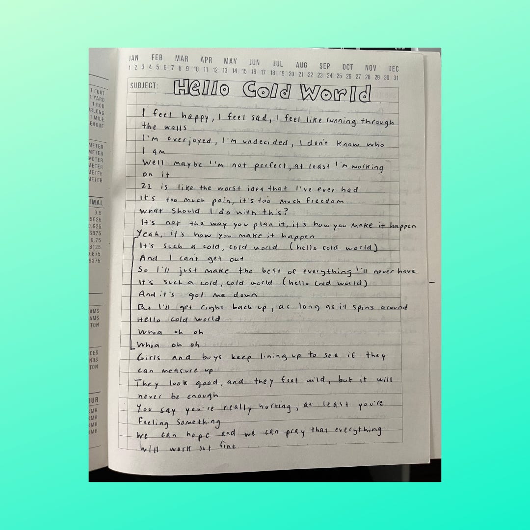 Picture of a page from my writing notebook for WLFCW, which features the lyrics to "Hello Cold World" by Paramore written out in my handwriting.