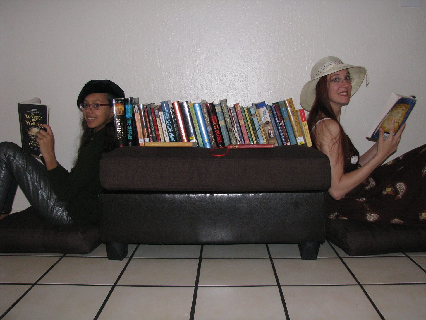 Mother and daughter as "bookends" each reading a book with a row of stories in between