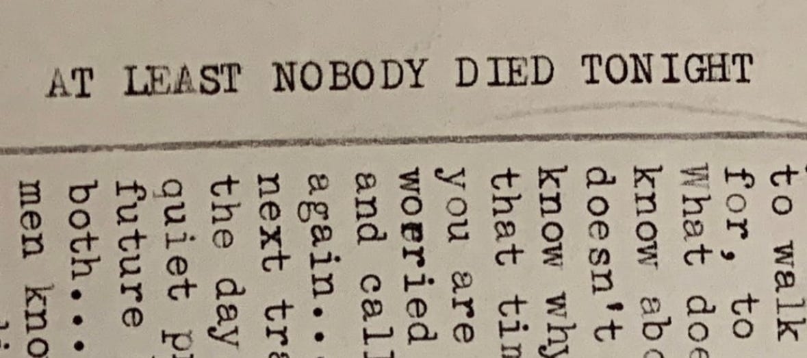A screenshot of the essay title "At Least Nobody Died Tonight" tapped out on a manual typewriter.