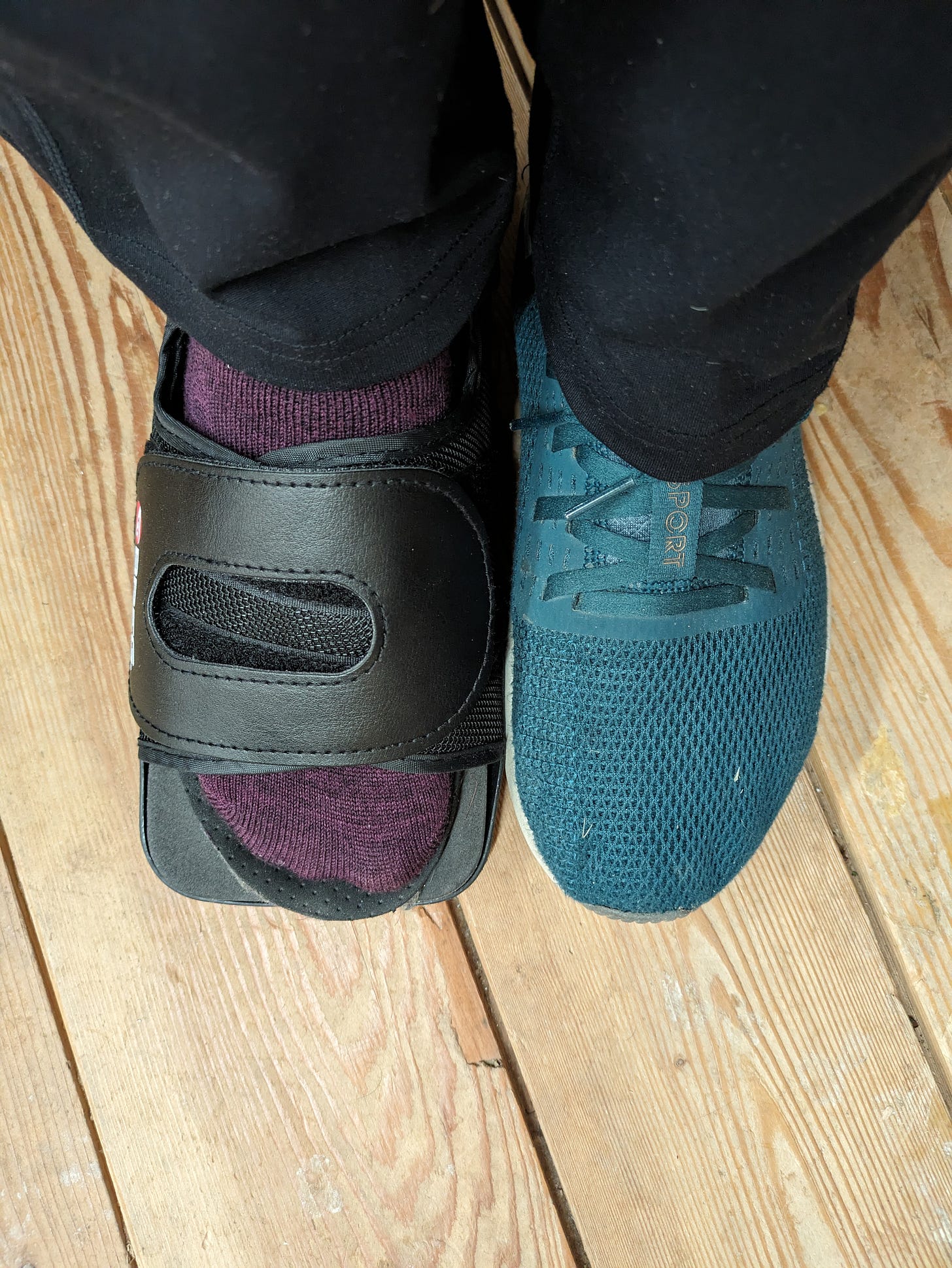 a picture of two feet, one wearing a tennis shoe and the other wearing a purple sock and an orthopedic shoe.