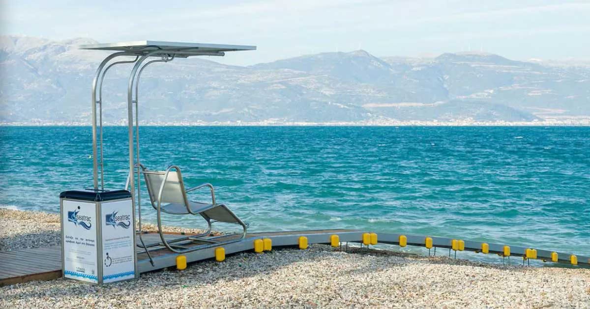 Chair on platform that provides unassisted access to the ocean water on a Greek beach.