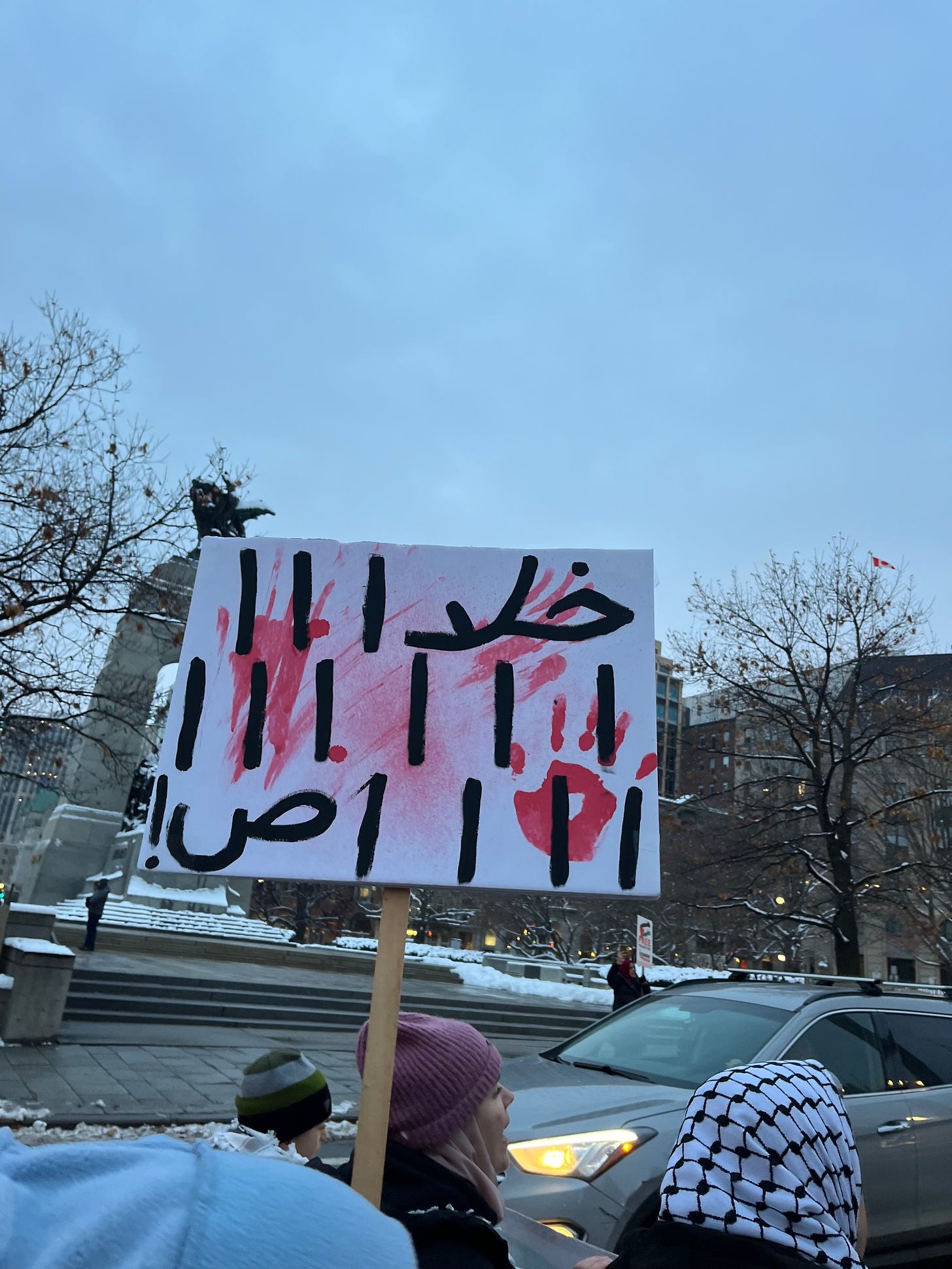 A pic of my favouritProtesters hold a sign for Gaza in Ottawa. It says “enooooooooooooooooooooooooooough” in Arabic