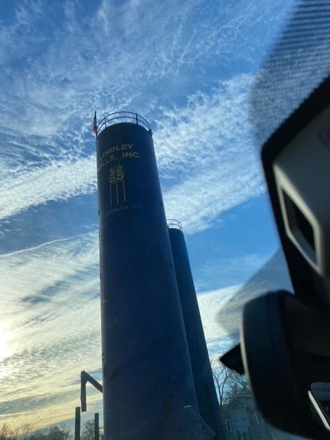 grain mill towers under blue sky