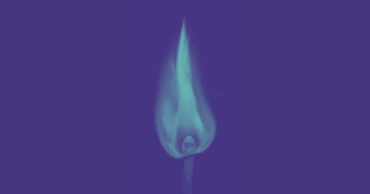 A flaming match with blue fire on a deep purple background.