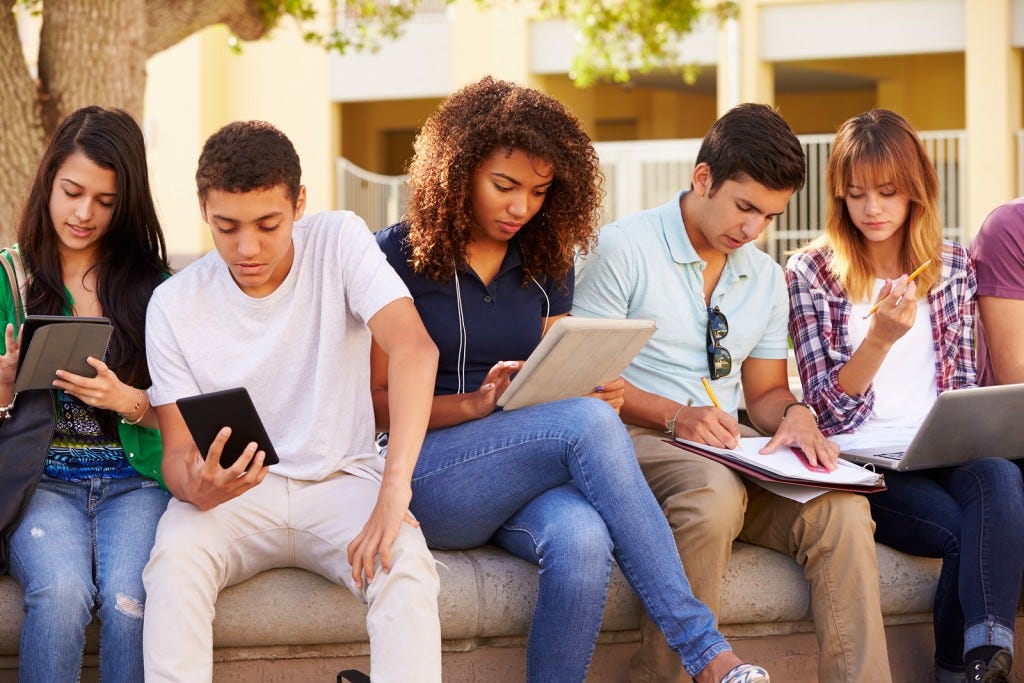 High School Students Collaborating On Project On Campus