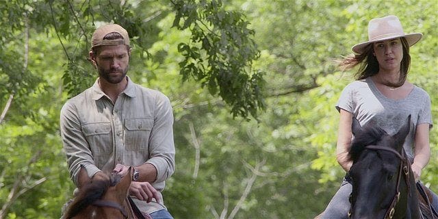 Walker Cordell riding horse with Geri baseball cap turned backward.