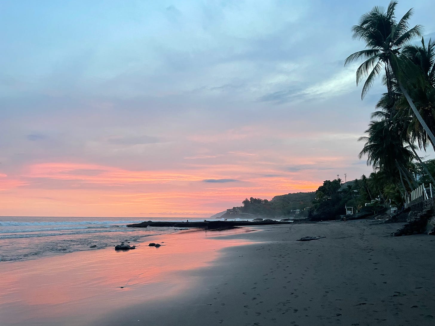 Sunset on a long expanse of beach on the Salvadoran coast