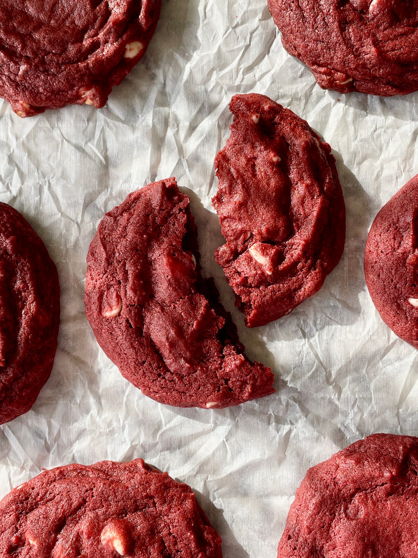top view of red velvet white chocolate cookies split in half