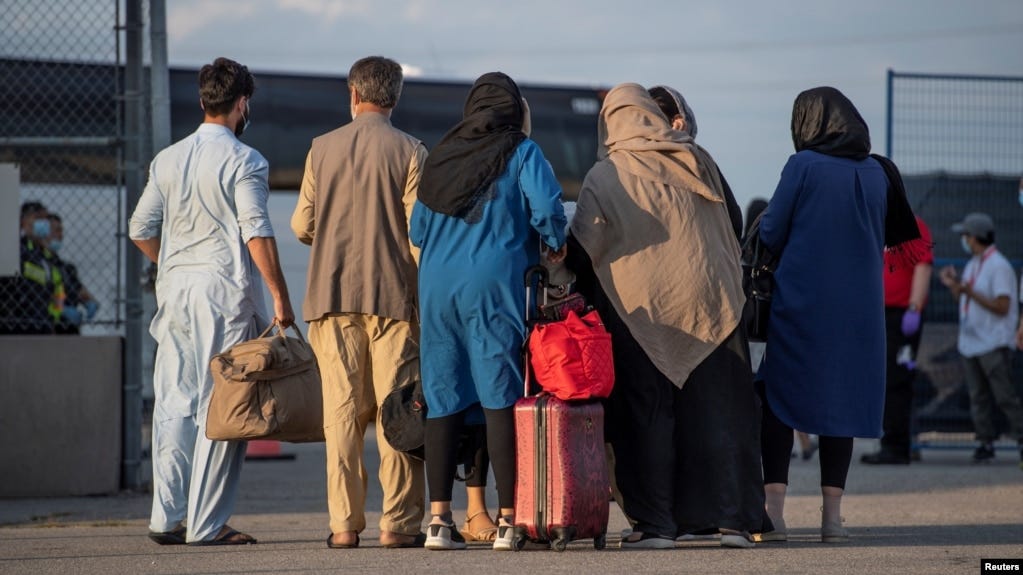 FILE - Afghan refugees who supported Canada's mission in Afghanistan prepare to board buses after arriving in Canada, at Toronto Pearson International Airport, Aug. 24, 2021. (Canadian Armed Forces Photo/Handout via Reuters)