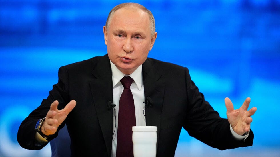 Russian President Vladimir Putin gestures as he speaks during his annual press conference in Moscow