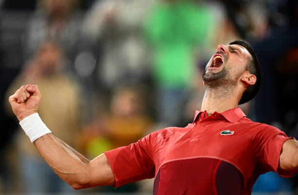 Novak Djokovic of Serbia celebrates victory against Lorenzo Musetti of Italy in the Men's Singles third round match at Roland Garros during Day Seven...