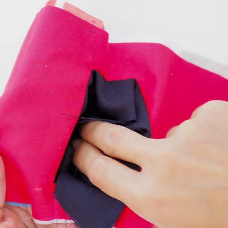 Push the blue fabric through the pocket hole