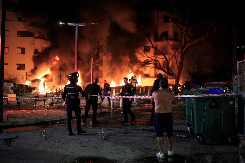 Firefighters and rescue personnel at a fire following a missile attack.
