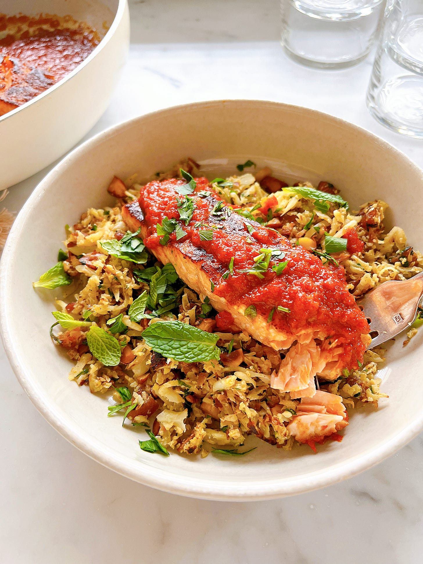 Red Pepper Salmon with Roasted Almond “couscous” in a bowl