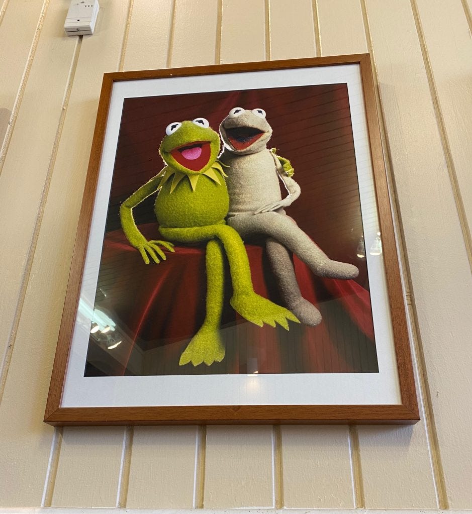 Kermit the Frog alongside the original Kermit puppet