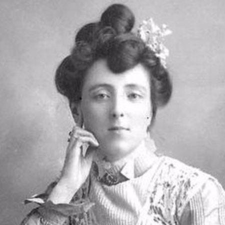 A picture of the author Lucy Maud Montgomery with flowers in her styled hair.