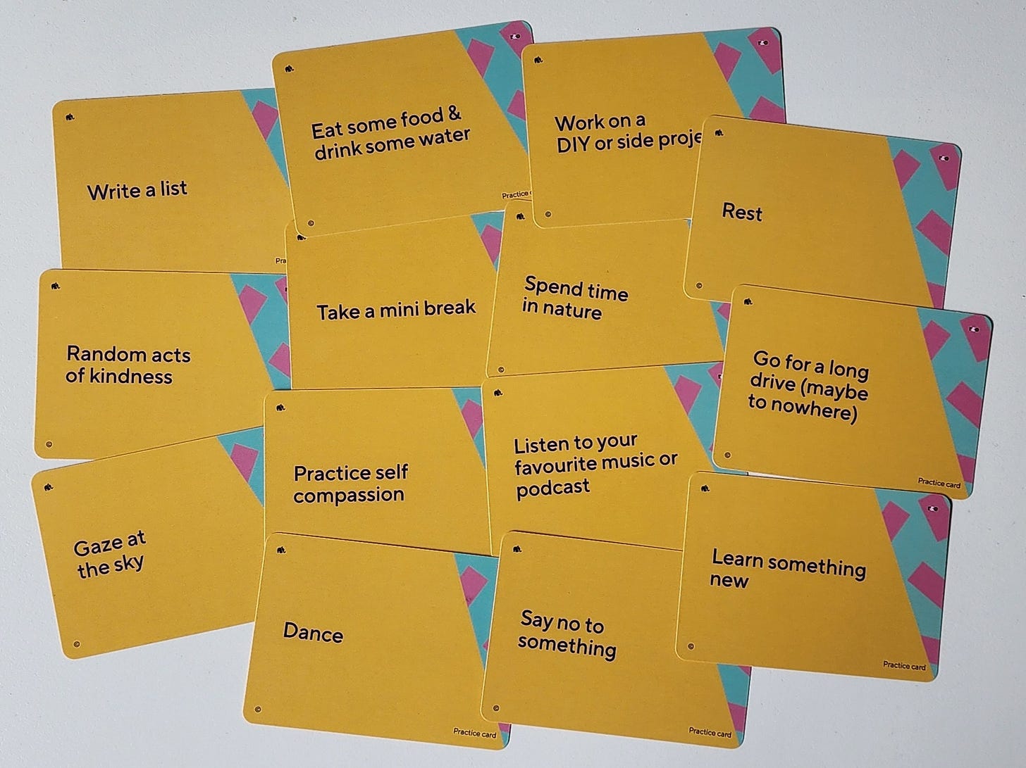 14 cards with gold backgrounds and white writing, depict a range of things we can practice to support our wellbeing and help us in a stress response, such as: write a list, gaze at the sky, learn something new, and so on. 14 cards with gold backgrounds and white writing, depict a range of things we can practice to support our wellbeing and help us in a stress response, such as: write a list, gaze at the sky, learn something new, and so on.