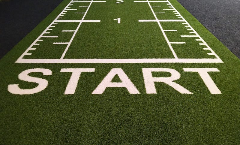 The word START painted in white on a green mat. The word START painted in white on a green mat.