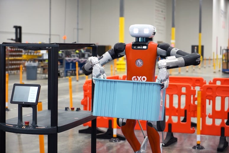 a Digit humanoid carrying a tote at a Spanx warehouse in Ga.