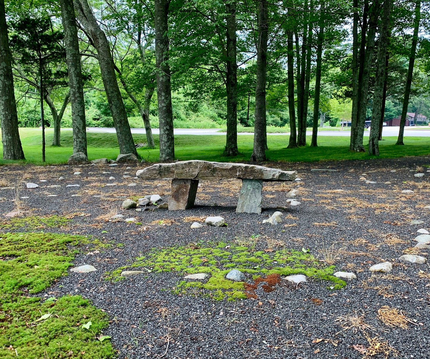 A stone bench in the center of a labyrinth