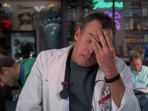 man in doctor's coat with his hand to his head in frustration (Dr. Cox from the TV show Scrubs)