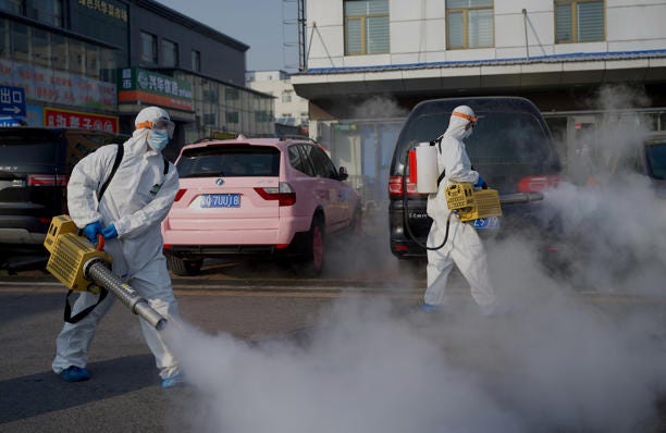Workers wearing hazmat suits disinfect the premises of a market in the Daxing district of Beijing on January 21, 2021, after a partial lockdown due to new Covid-19 coronavirus infections was imposed on the Chinese capital on January 20. China is combatting a surge in respiratory illnesses including mycoplasma pneumonia that has overwhelmed hospitals in the northern part of the country.