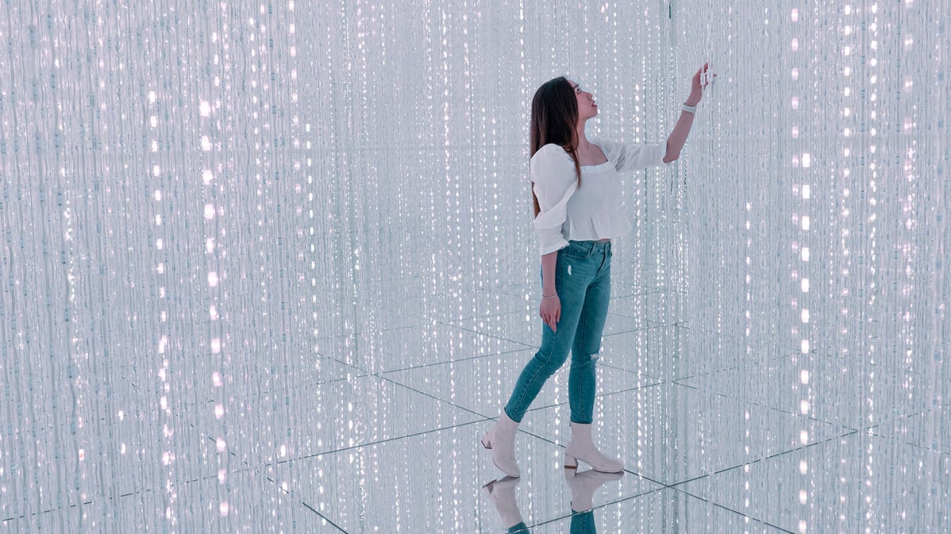 A woman poses for pictures inside the teamLab SuperNature museum at the Venetian Macao resort and casino in Macao, China, on February 22, 2023.