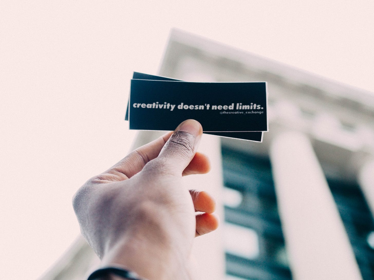 person holding black and white quote-printed card person holding black and white quote-printed card