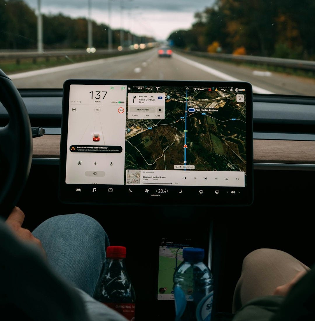 person holding white ipad inside car person holding white ipad inside car