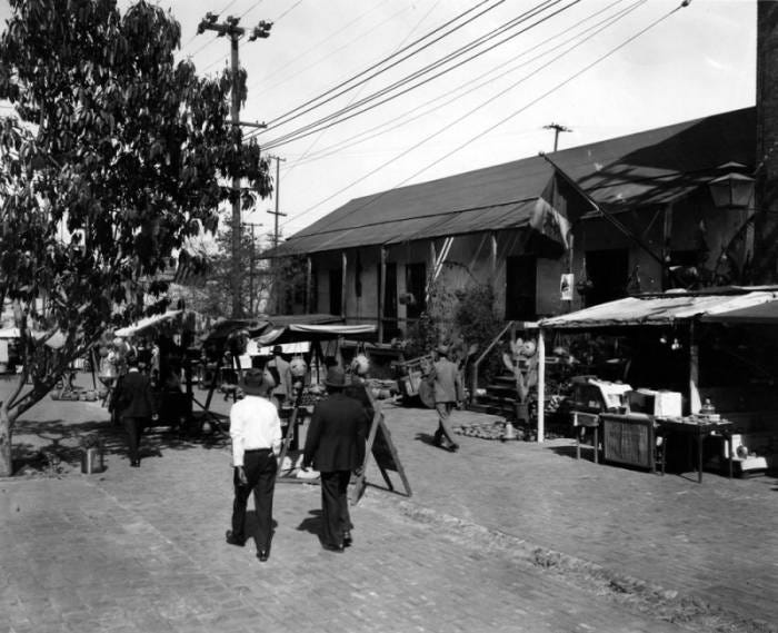 Avila Adobe, Olvera Street marketplace, and pedestrians Avila Adobe, Olvera Street marketplace, and pedestrians